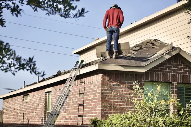 Professional roofer working on a residential roof in Central Square